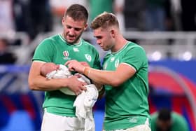 Ireland's Stuart McCloskey holds newborn son Kasper as he speaks with Garry Ringrose after the Rugby World Cup game against Scotland at Stade de France. (Photo by Laurence Griffiths/Getty Images)