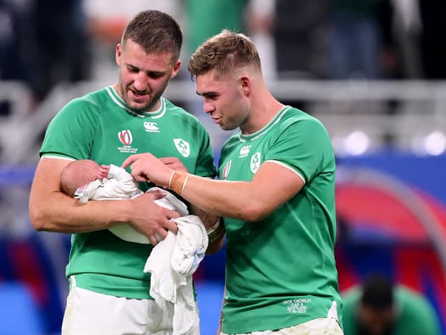 Ireland's Stuart McCloskey holds newborn son Kasper as he speaks with Garry Ringrose after the Rugby World Cup game against Scotland at Stade de France. (Photo by Laurence Griffiths/Getty Images)