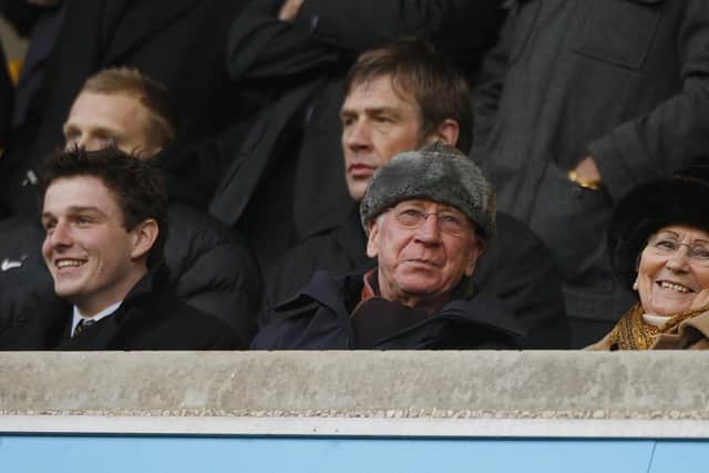 Sir Bobby Charlton (centre) and his wife Norma (right) in the stands