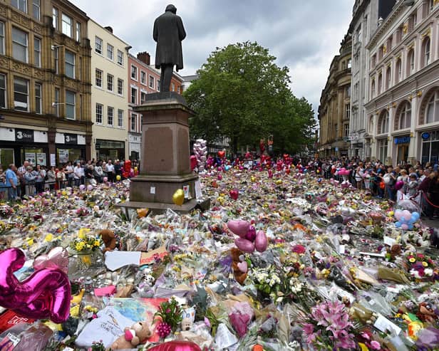 Floral tributes to victims of Manchester Arena bombing cover St Ann's Square, Manchester on in 2017, five days after the attack killed 22 people. A victim of the blast was Martyn Hett, whose name has been given to legislation to require social venues and local authorities to have preventative plans against possible terror attacks