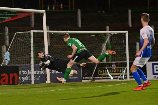 Glenavon goalkeeper Rory Brown pulls off a save to deny Glentoran's Terry Devlin