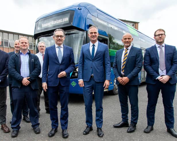 Wrightbus CEO Jean-Marc Gales and  Shadow Secretary of State for Northern Ireland Peter Kyle with members of the Wrightbus team at the company's factory and headquarters in Ballymena