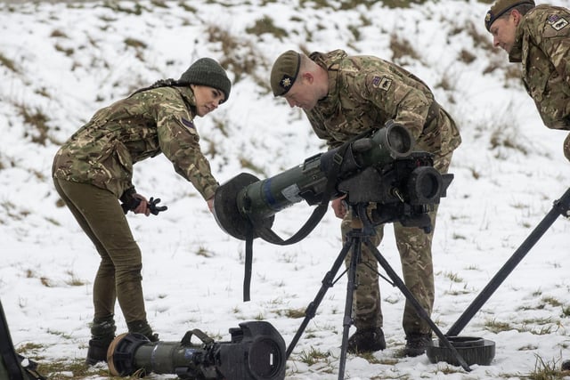 The Princess of Wales, Colonel of the Irish Guards, is shown a weapon systems used by the Irish Guards