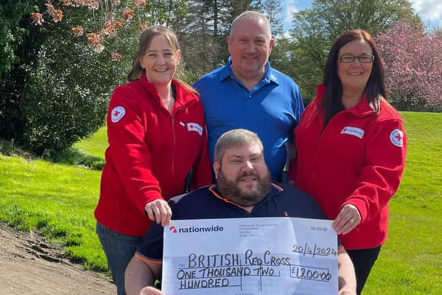 Tim Webb and his dad Ivan present a cheque of £1,200 to Vikki and Faith of the British Red Cross following his 'Webbers Wheels' event