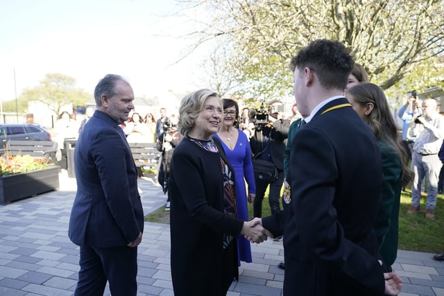 Former US secretary of state and Chancellor of Queen's University Belfast, Hillary Clinton, is greeted by pupils as she arrives at Limavady High School
