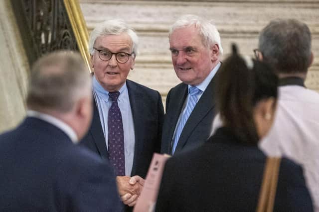 Sir John Holmes (left) shakes hands with former Taoiseach Bertie Ahern, during a meeting of the British-Irish Parliamentary Assembly Plenary, at Stormont, to mark the 25th anniversary of the Good Friday Agreement.