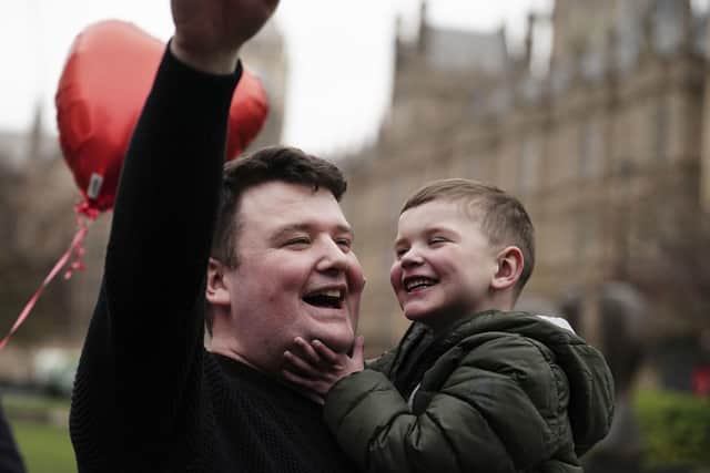 Daithi MacGahbann and his father Mairtin MacGahbann outside the Houses of Parliament in London, before watching the NI Executive Formation Bill pass through the Commons
