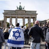 People take part in a solidarity demonstration with Israel on Pariser Platz at the Brandenburg Gate, in Berlin, Sunday, Oct. 8, 2023. (Fabian Sommer/dpa/via AP)