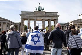 People take part in a solidarity demonstration with Israel on Pariser Platz at the Brandenburg Gate, in Berlin, Sunday, Oct. 8, 2023. (Fabian Sommer/dpa/via AP)