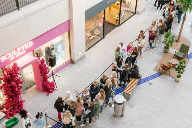 Queues in the Victoria Square shopping centre in Belfast on Saturday morning before the opening of the eye-catching pink Sculpted By Aimee shop. Irish make-up entrepreneur Aimee Connolly spoke of her delight after crowds turned out for the opening of her first flagship store in Northern Ireland Photo: Elyse Kennedy/PA Wire
