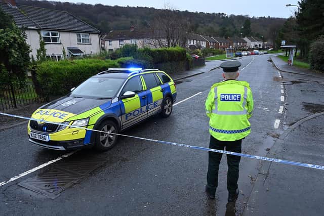 Police attending the security alert in Holywood, County Down, after a suspicious device was thrown at a house causing a small fire
