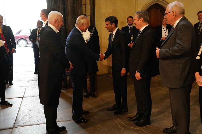 King Charles III shakes hands with Prime Minister Rishi Sunak as Speaker of the House of Commons, Sir Lindsay Hoyle (left) and Labour leader Sir Keir Starmer (second right) look on during his visit to Westminster Hall at the Palace of Westminster to attend a reception ahead of the coronation.