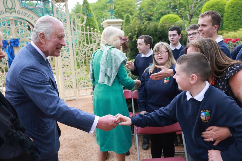 King Charles III and Queen Camilla greet schoolchildren during a visit to open the new Coronation Garden on day one of their two-day visit to Northern Ireland in Newtownabbey (Photo by Chris Jackson/Getty Images)