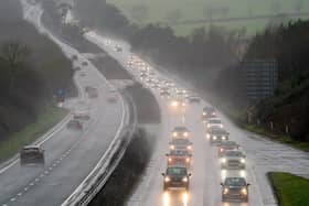 Cars make their way through heavy rain