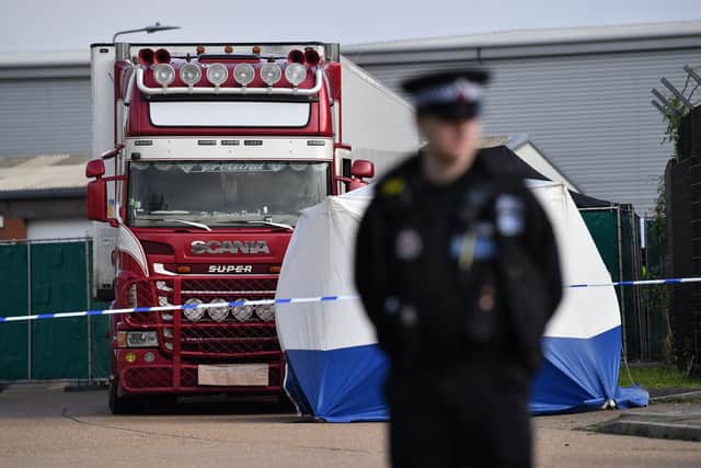 A police officer secures the cordon at at the scene where a lorry was found containing 39 dead bodies