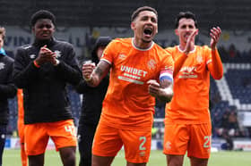 Rangers' James Tavernier (centre) celebrates with fans and team-mates. (Photo by Andrew Milligan/PA Wire)