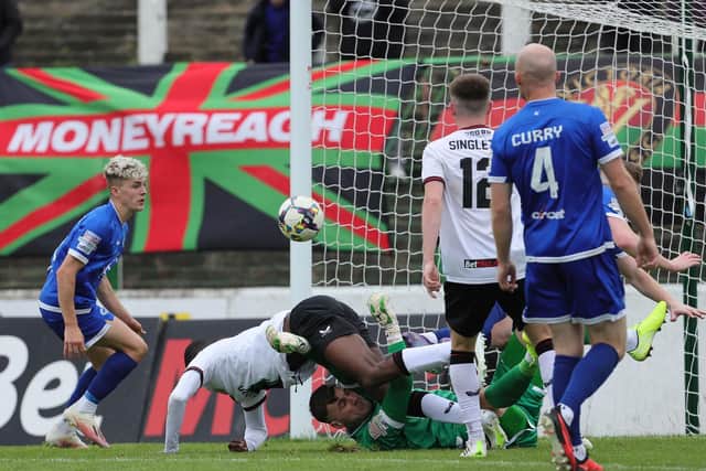 Dungannon Swifts goalkeeper Conor Mitchell and Glentoran's Junior tangle at The Oval on Saturday. (Photo by David Maginnis/Pacemaker Press)
