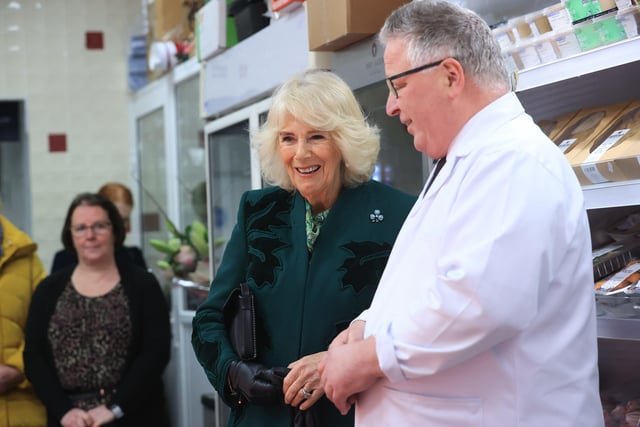 Queen Camilla meets the owner of Coffey's Butchers during a visit to Lisburn Road in Belfast