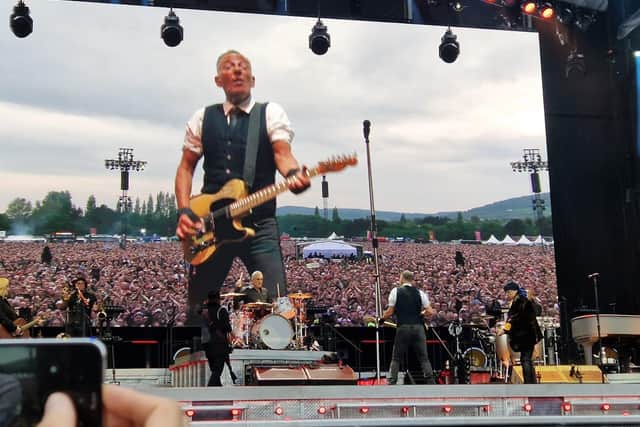 Fans enjoying Bruce Springsteen as seen on a screen at the big stage in mild weather at Boucher Playing Fields in Belfast at Thursday's concert