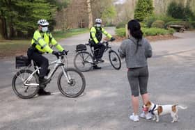 PSNI officers talk to a member of the public as they patrol Ormeau Park in Belfast in April 2020, the early days of lockdown.  Pic: Stephen Davison