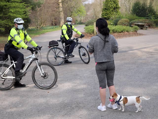 PSNI officers talk to a member of the public as they patrol Ormeau Park in Belfast in April 2020, the early days of lockdown.  Pic: Stephen Davison