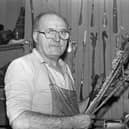 Belfast shoemaker Pat McKernan with his collection of shoehorns, some of which bear a resemblance to riding crops, pictured in his shop on Donegall Street at the end of October 1981. Picture: Darryl Armitage/News Letter archives