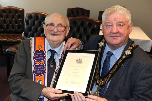 Mayor, Cllr Steven Callaghan presents Cauley Moffatt with a certificate in recognition of his years of service to the Orange Institution and the local community.