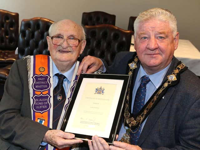 Mayor, Cllr Steven Callaghan presents Cauley Moffatt with a certificate in recognition of his years of service to the Orange Institution and the local community.
