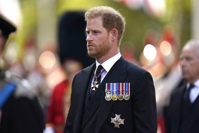 The Duke of Sussex walks behind the coffin of Queen Elizabeth II, draped in the Royal Standard with the Imperial State Crown placed on top, as it is carried on a horse-drawn gun carriage of the King's Troop Royal Horse Artillery, during the ceremonial procession from Buckingham Palace to Westminster Hall, London, where it will lie in state ahead of her funeral on Monday.