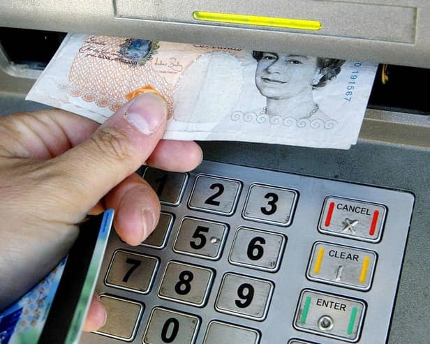 Money being withdrawn from an ATM