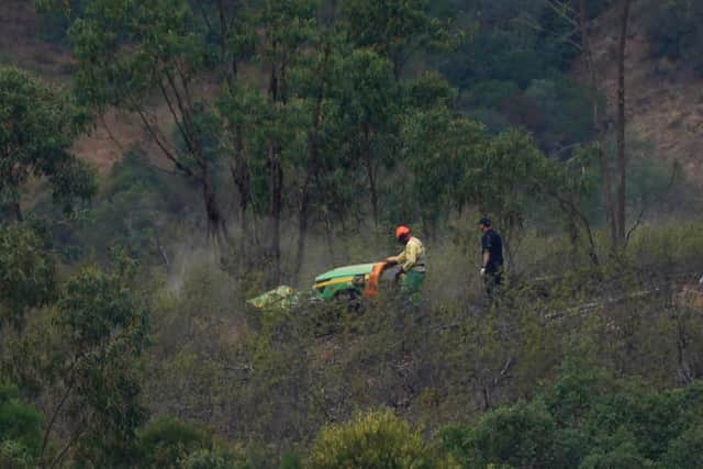 Personnel clear undergrowth with machinery at Barragem do Arade reservoir, in the Algave, Portugal, as searches continue as part of the investigation into the disappearance of Madeleine McCann. The area is around 50km from Praia da Luz where Madeleine went missing in 2007.