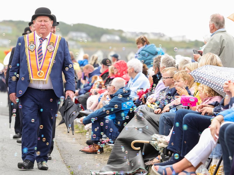 The parade makes its way through the village