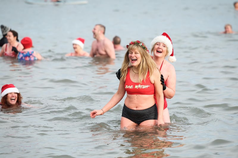 Swimmers from north Down take part in the annual Santa Splash at Helens Bay beach, County Down. 
The Helens Baywatch swimmers group organised the event in aid of the RLNI and Marie Curie Hospice.