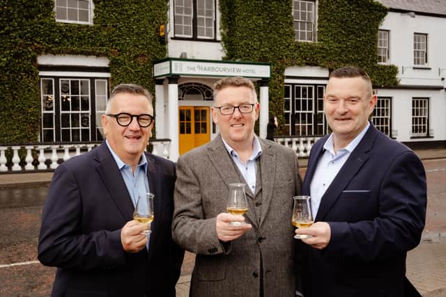 Co-owners Darryl McNally and Adrian McLaughlin toast the official opening of the Harbourview Hotel in Carnlough with general manager, Paul Truscott. Picture: Bradley Quinn