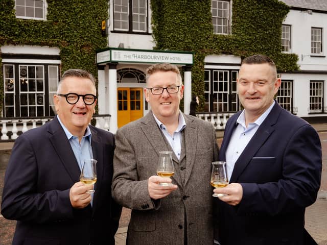 Co-owners Darryl McNally and Adrian McLaughlin toast the official opening of the Harbourview Hotel in Carnlough with general manager, Paul Truscott.  Picture: Bradley Quinn