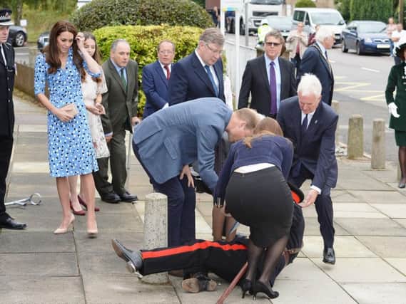 The Duke of Cambridge comes to the aid of Jonathan Douglas-Hughes, Vice Lord-Lieutenant of Essex when he took a tumble as he arrived at Stewards Academy in Harlow, Essex