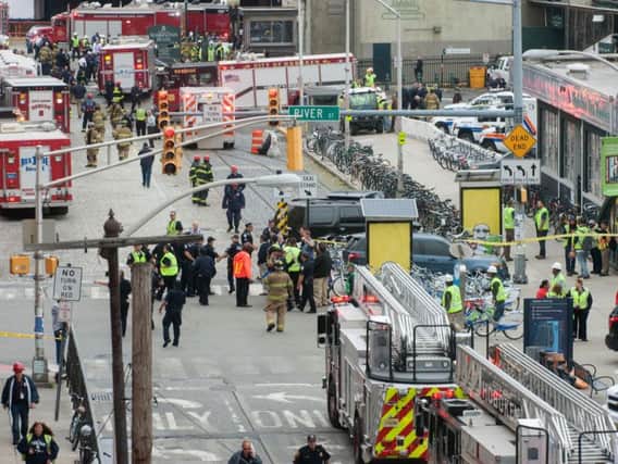 Emergency personnel work outside the rail station after a train crash in Hoboken, New Jersey. Pic: PA