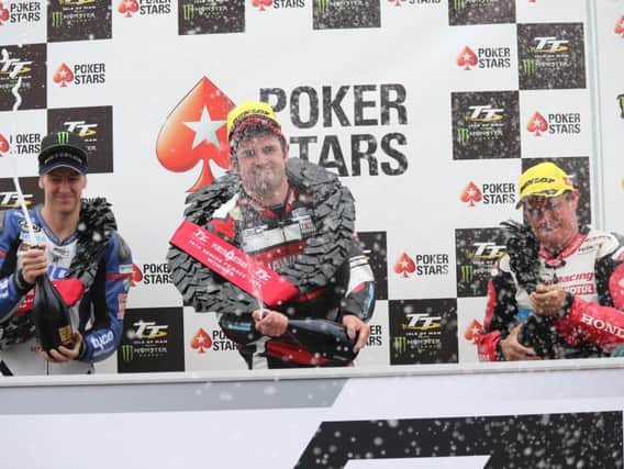 Michael Dunlop celebrates victory in the Senior TT in 2016 with runner-up Ian Hutchinson (left) and John McGuinness.