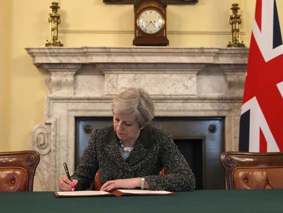 Prime Minister Theresa May signs the Article 50 letter, as she prepares to trigger the start of the UK's formal withdrawal from the EU