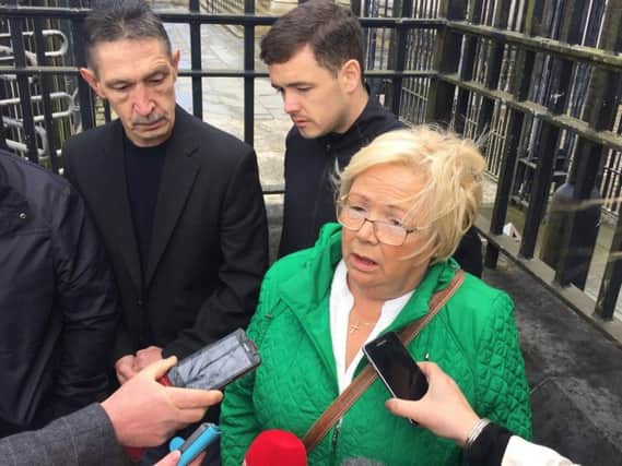 Helen Deery, Manus Deery's sister, speaks to the media outside Londonderry Courthouse after a coroner ruled that British soldier Private William Glasgow, who shot the teenager dead in Londonderry in 1972, was unjustified in discharging the fatal round.