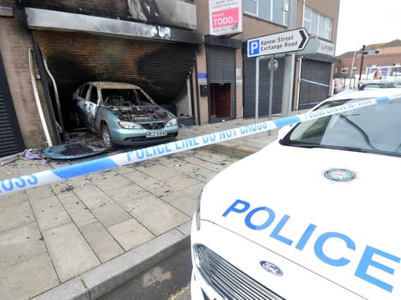 Police at the scene of a suspected arson attack at a hairdressers in Larne