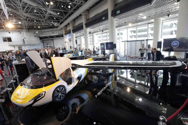 The AeroMobil prototype of a flying car. The light frame plane whose wings can fold back, like an insect is boosted by a rear propeller.