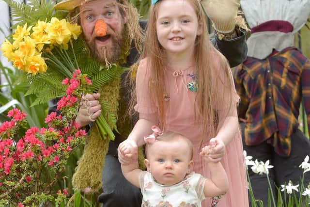 Seven Year old Ella McErlean, and nine-month old sister Maisie are surprised by scarecrow Paul Currie during a visit to Barnett Demesne which is hosting Belfasts annual Spring Fair on the weekend of 29-30 April.  A host of family free fun from pony rides to arts and crafts as well as craft and plant stalls, music and dance plus a scarecrow display is taking place between 1.30pm-5.30pm