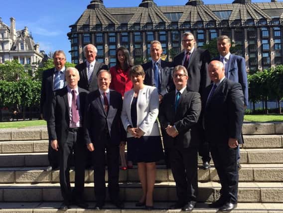 Handout photo issued by the DUP of leader Arlene Foster with the party's ten MPs outside the Houses of Parliament in Westminster, London, following last week's General Election.