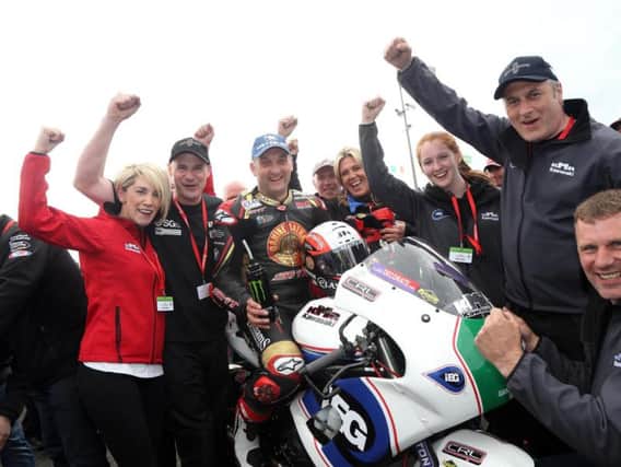 Ryan Farquhar's KMR Kawasaki team celebrates Michael Rutter's Supertwins victory at the North West 200 in May.