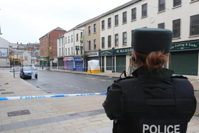 A PSNI officer pictured at the scene of the crime in William Street on Sunday. (Photo: Presseye)