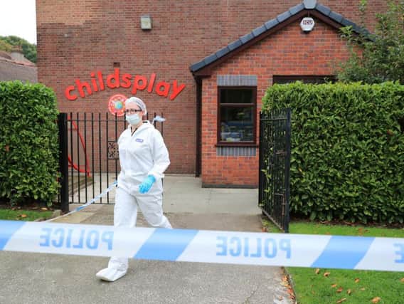 A forensic officer at the Childsplay Nursery in Wavertree, Liverpool, where detectives are investigating reports that an armed man was seen there before fleeing with a second man on a motorcycle.