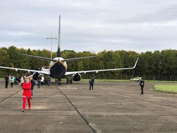 Picture taken with permission from the twitter feed of @zulu_wooloo of the police officers by the Ryanair plane, that was from Lithuania to Luton, at Stansted airport where it was escorted into by RAF jets.