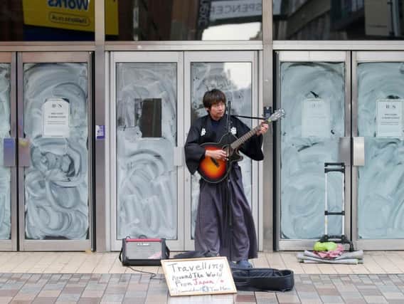 A lone busker braves the weather