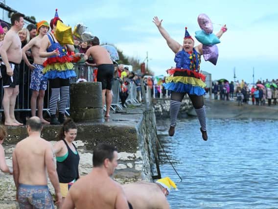 Angela McClements takes the plunge into Carnlough Harbour during the traditional New Year's Day swim